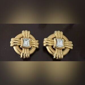 Costume gold colored clip on earrings with rectangular zirconia crystals.